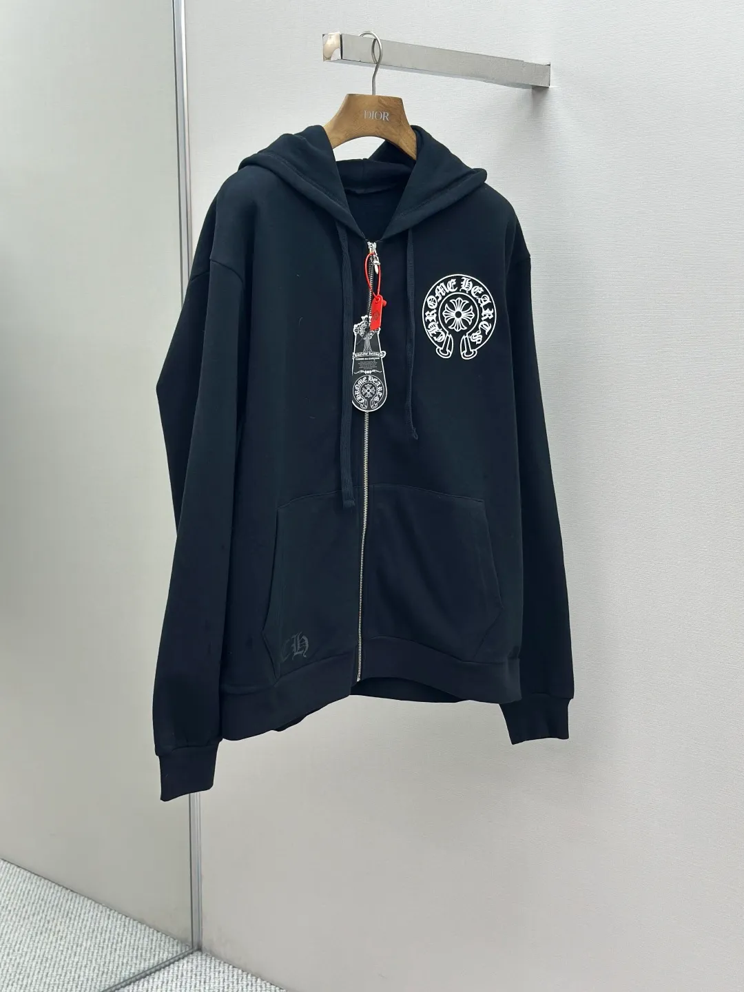 P480 Chrome Hearts letter-printed zipper jacket. Customized plain suede cotton. Delicate and smooth, comfortable and close to the skin. It is made of deep black as the base. Plain white lines are neatly cracked. The cross pattern on the front is precisely embellished on the chest, while the gray CH pattern is looming on the hem to control the visual focus. The scroll mantra is outlined on the back like an ancient seal. Ruggedness and sophistication coexist. The zippered hooded silhouette deconstructs the lazy drape carrying suede. A rock oracle that whispers that I am the rule. A rebellious ceremony about wearing and performing. Process 1: Use glue printing. The printing is modified three times by the film screen. Use glue liquid paint to print the pattern on the fabric. Bake the fabric to fix the printing pattern. Process 2: The fabrics are washed and have a better hand feel. Not easy to deform. Not easy to shrink. Not easy to fade. Maintain long-term beauty. Accessories: Customized CH zipper. Customized CH trademark. Version: Loose version. Size: S M L XL